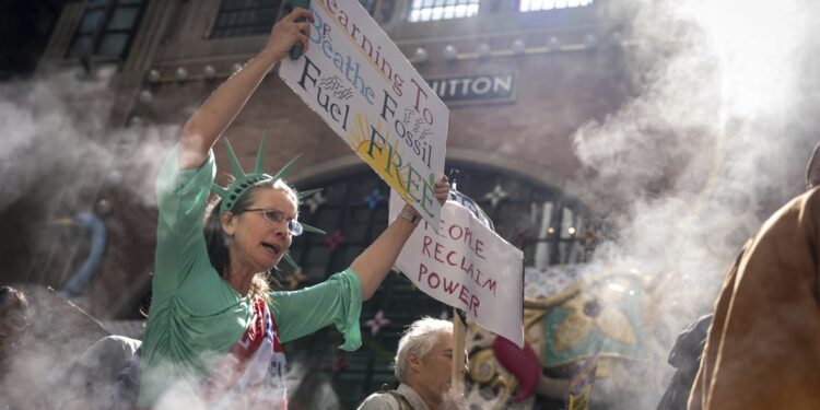 Marchers gather in worldwide protest of financial institutions “profiting off the climate crisis”