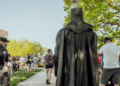 A man in a Batman costume stood silently on a Milan train, a few metres from a woman who appeared pregnant, and never once interacted with her or anyone else — yet his presence alone was followed by a jump in the share of passengers who offered her a seat from roughly one in three to two in three
